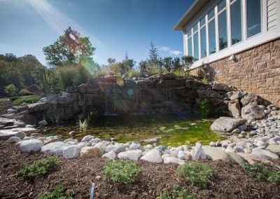 Natural boulder waterfall and pond water feature by Frederick Landscaping Maryland