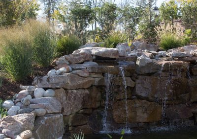 Natural boulder waterfall and water feature by Frederick Landscaping Maryland