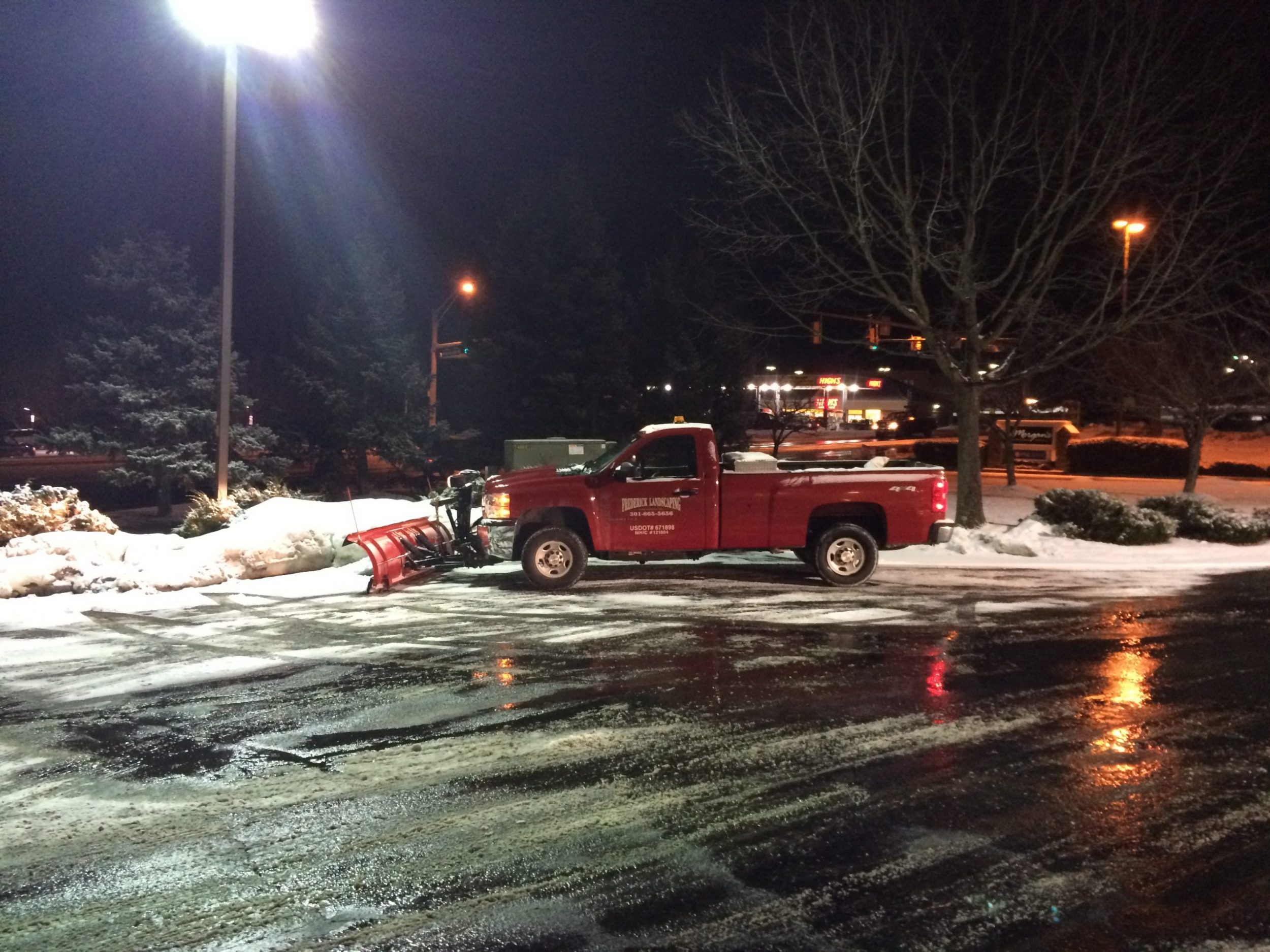 Snow removal from parking lot by Frederick Landscaping Maryland